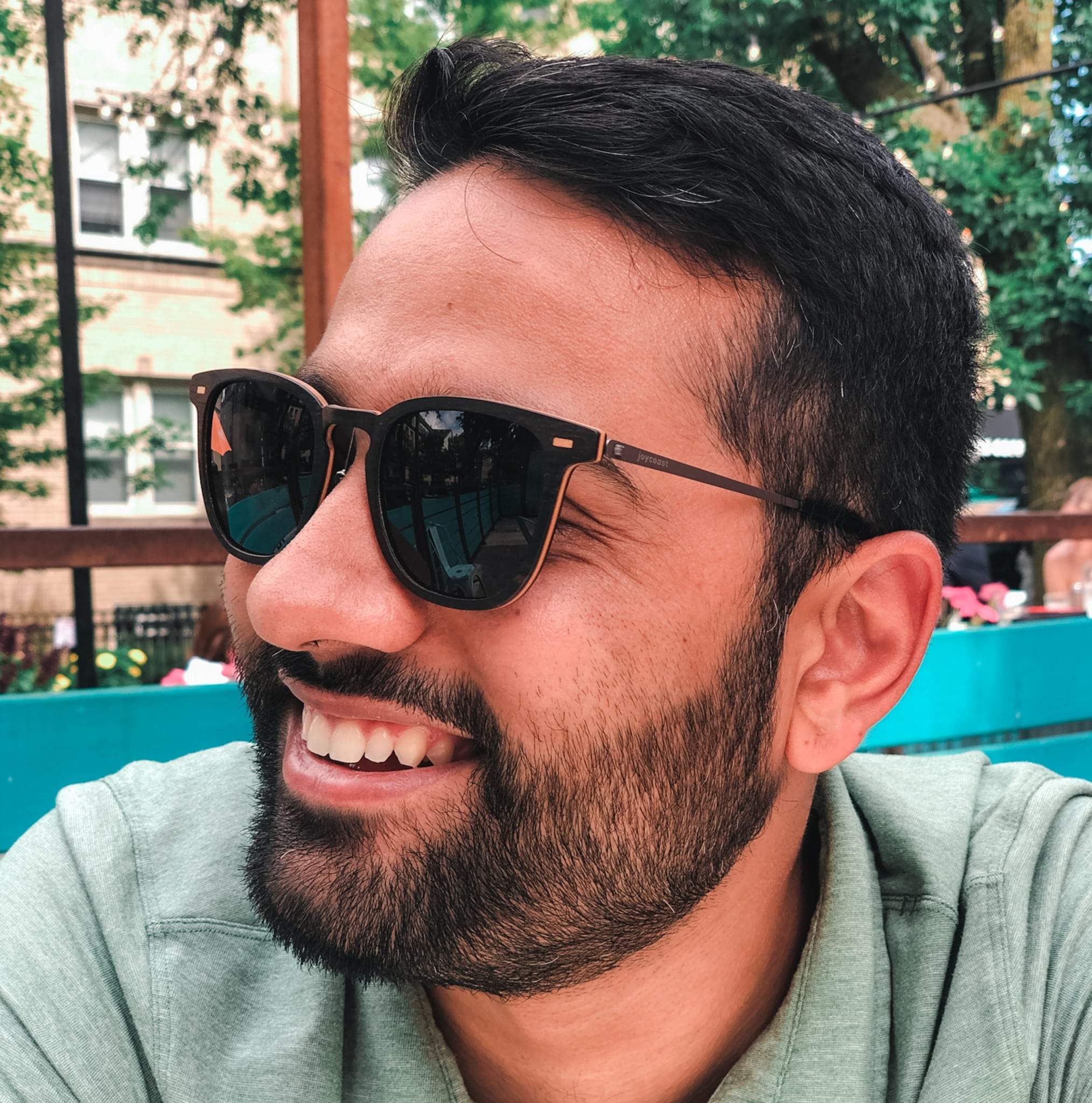 Sunglasses on man in profile with black frames and tinted lenses