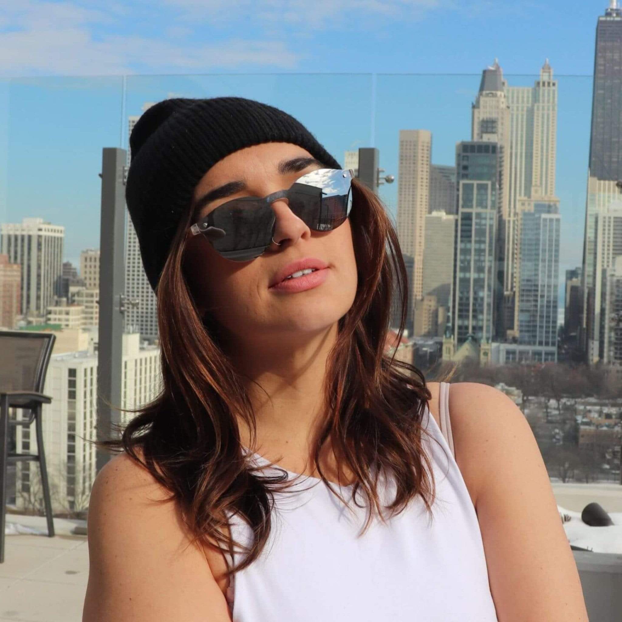 Round sunglasses with dark lenses and black frame, silver accents.