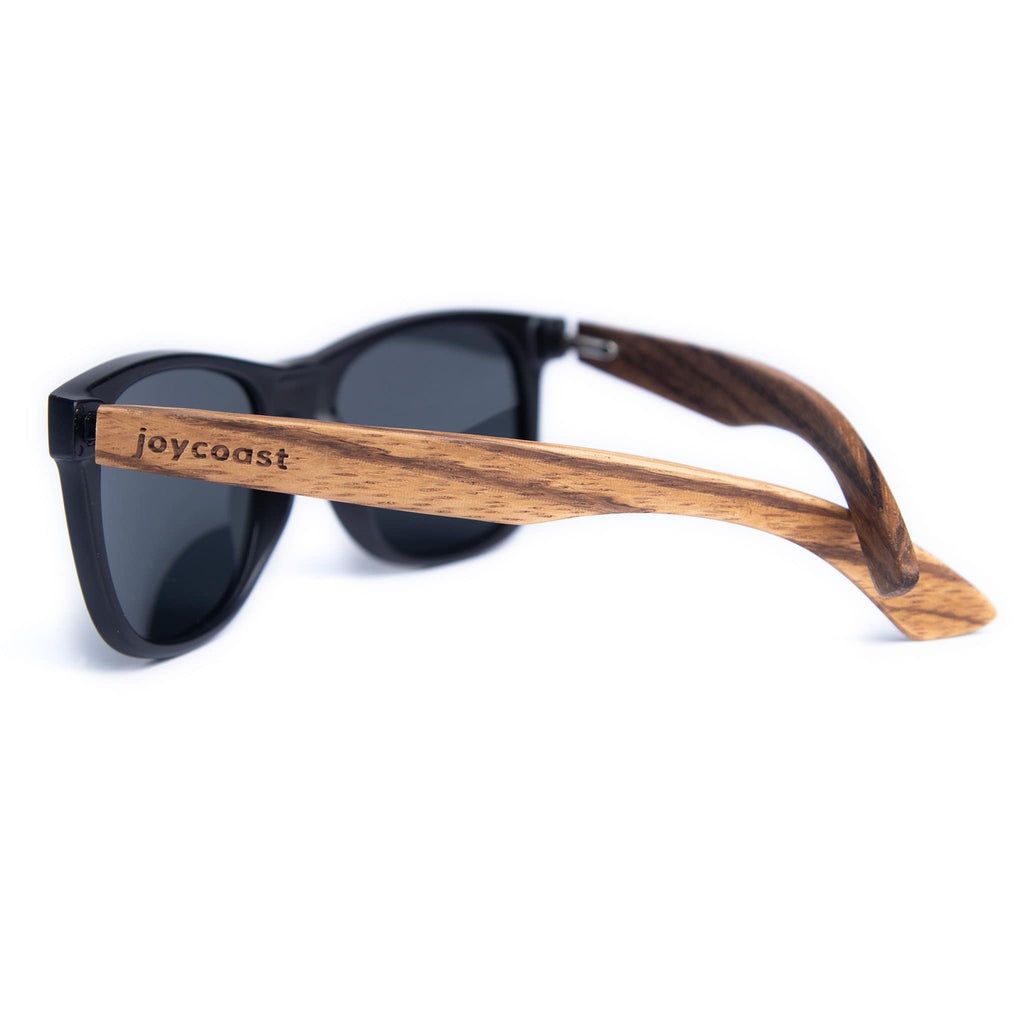 Wooden sunglasses side view with dark lenses, black frame and brown wooden temple arms